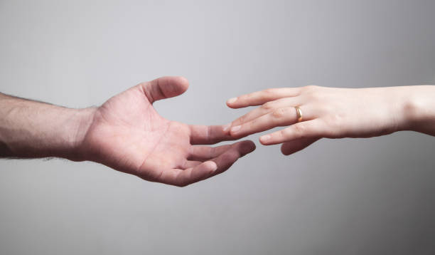 istock Man and woman hands on grey background. 1214429456