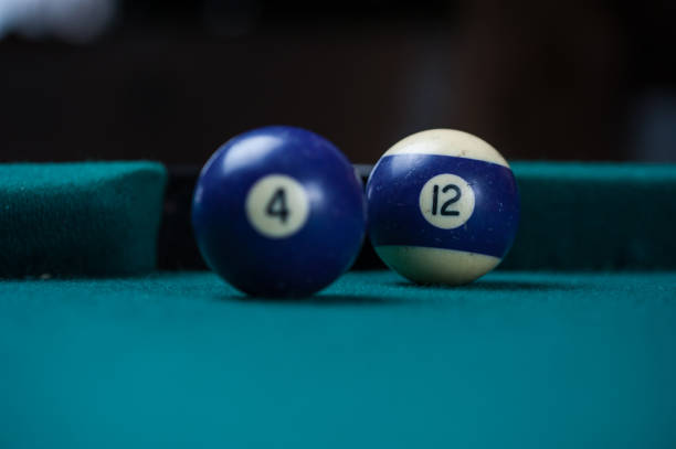 istock Billiards balls and cue on billiards table. Billiard sport concept. 1214429486