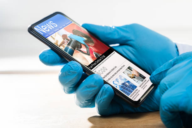 istock Hands In Gloves Checking Coronavirus News On Mobile 1214429531