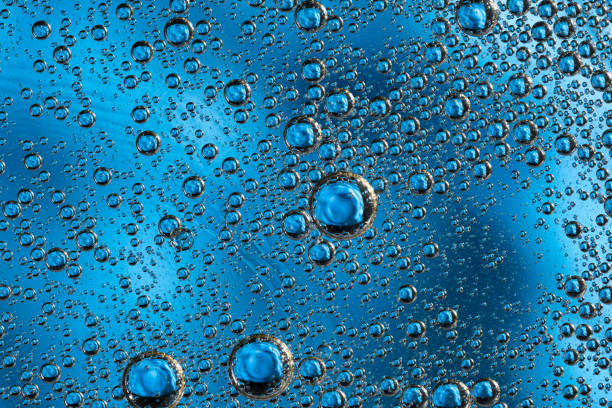 istock Large beautiful Oxygen bubbles underwater on a blue background macro. 1214429748