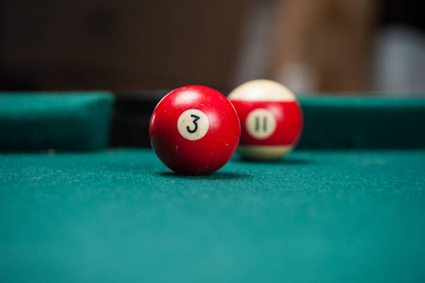 istock Billiards balls and cue on billiards table. Billiard sport concept. 1214429941