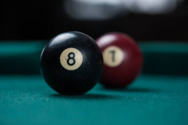 istock Billiards balls and cue on billiards table. Billiard sport concept. 1214429984