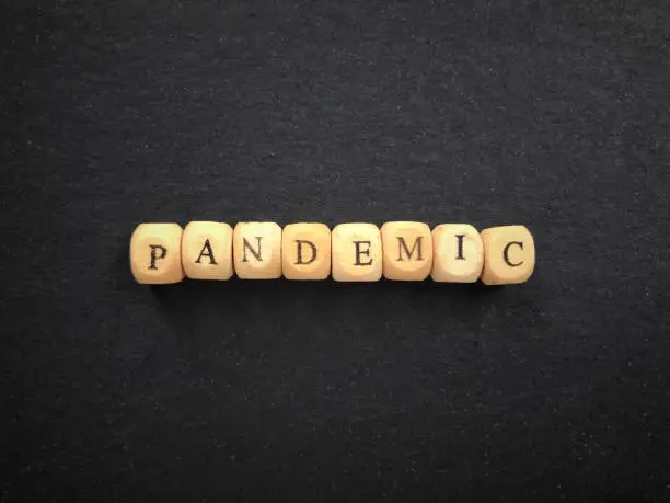 PANDEMIC written on wooden blocks. Vintage styled background.