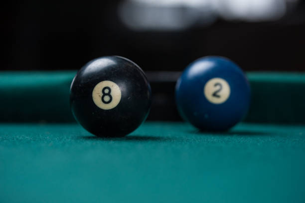 istock Billiards balls and cue on billiards table. Billiard sport concept. 1214431074
