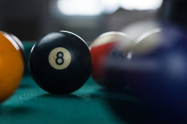 istock Billiards balls and cue on billiards table. Billiard sport concept. 1214431136