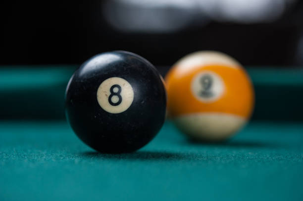 istock Billiards balls and cue on billiards table. Billiard sport concept. 1214431315