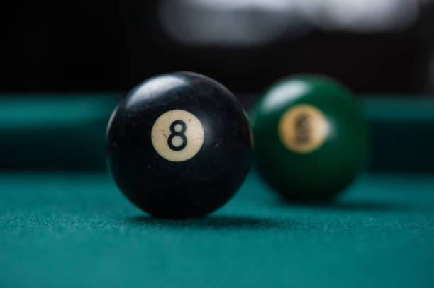 istock Billiards balls and cue on billiards table. Billiard sport concept. 1214431384