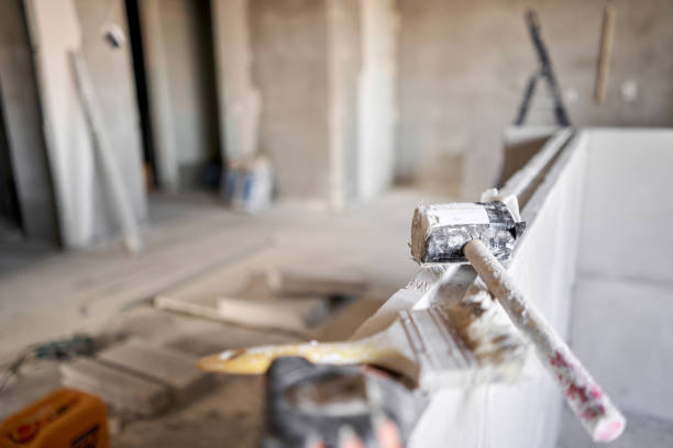istock Tools on Gypsum plate. Construction of internal walls in the apartment using a plaster concrete plate with groove ridge. 1214432006