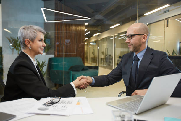 istock Mature Business People Shaking Hands 1214434070