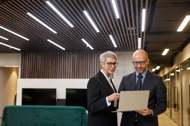 Two Business People in Office Lobby