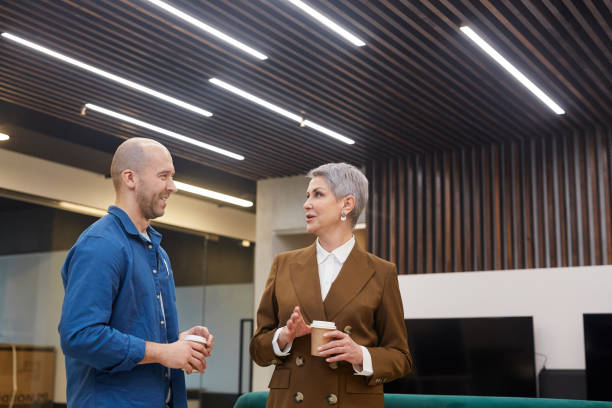 istock Mature Female Manager Talking to Client in Lobby 1214434096