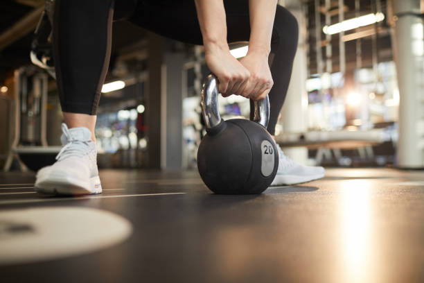 istock Close Up Woman Swinging Kettlebell 1214435297