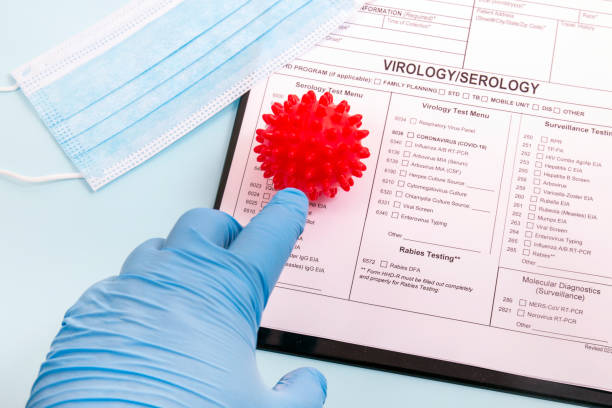 istock Doctor's hand holding red virus ball concept 1214435646