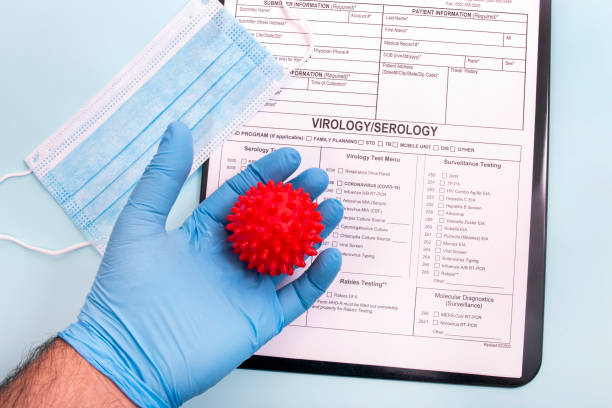 istock Doctor's hand holding red virus ball concept 1214435653