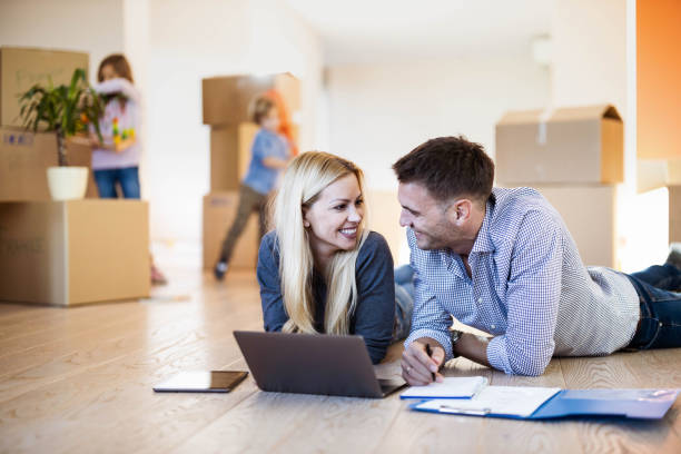 istock Happy parents talking while making plans on the floor at new apartment. 1214438881