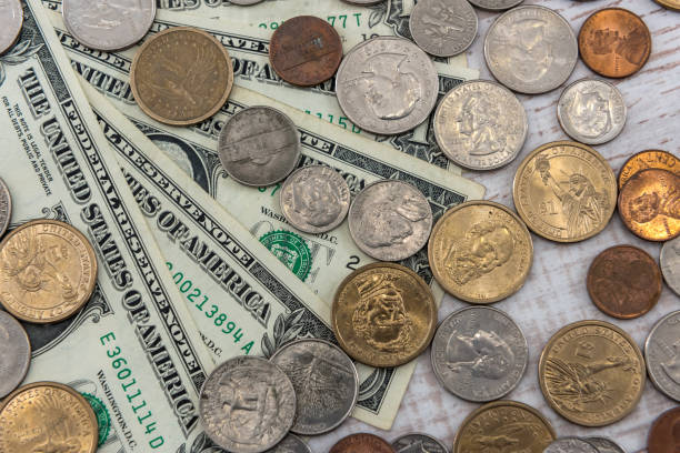 istock US 1 dollar bills with coin cent on wooden desk. same money conccept. 1214440169