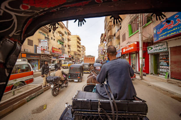 daily life on the streets of edfu town in egypt, seen from the view of a taxi carriage - desert egyptian culture village town imagens e fotografias de stock