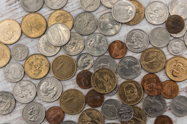 istock different us cent, one dollar coin on wooden desk. 1214440591