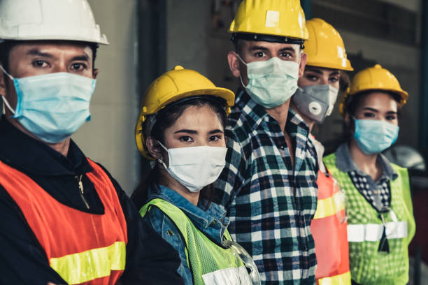 arbeiter mit gesichtsmaske schützen vor dem ausbruch der corona virus disease 2019. - stoppschild fotos stock-fotos und bilder