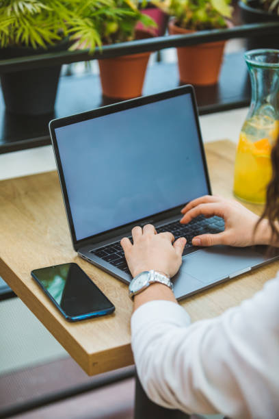 istock woman working on laptop in cafe white screen freelancer concept 1214440886