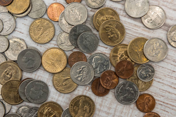 istock different us cent, one dollar coin on wooden desk. 1214441681