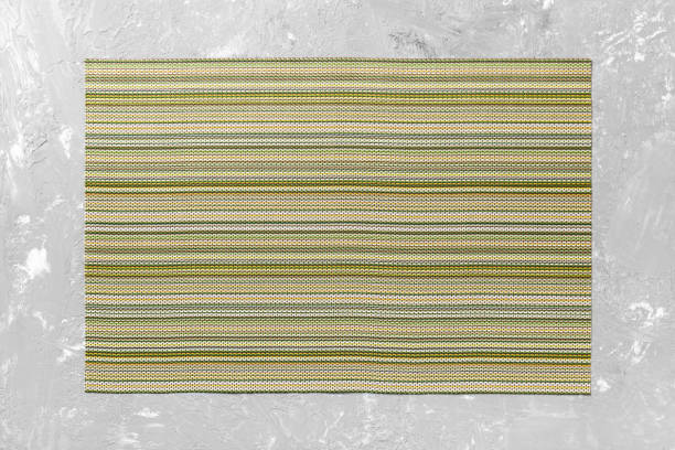 Top view of textile green mat for dinner on cement background with copy space