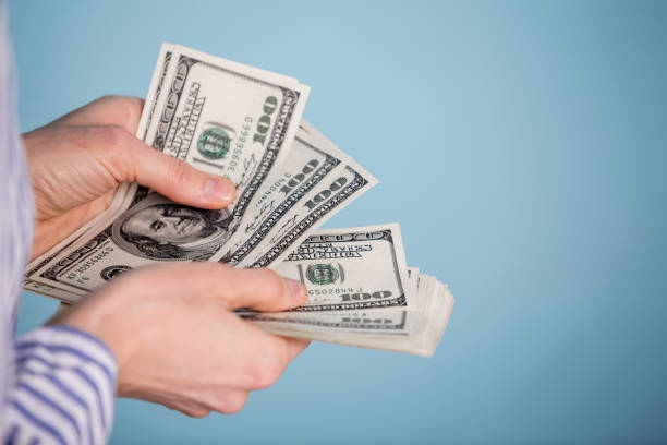 istock money in a hand 1214443563
