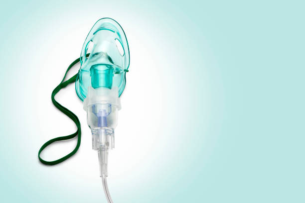 istock Close up image of an oxygen mask from front on green gradient. 1214444681