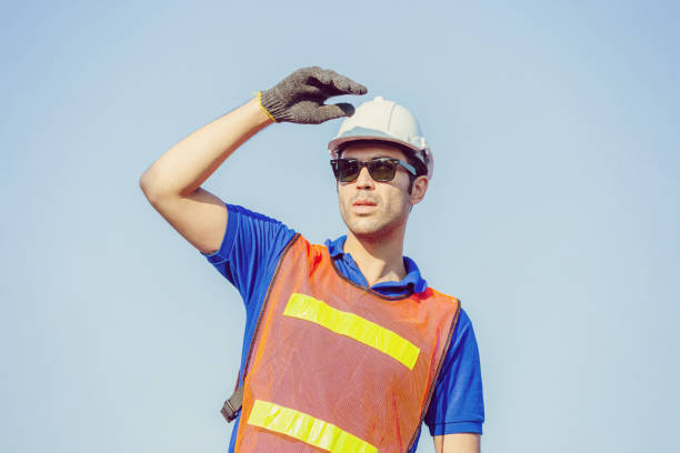 istock Cheerful shipping company workers working at the harbor, Engineering man looking to the sky 1214446838