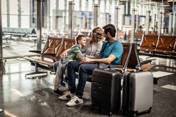 istock Happy family talking while waiting their transportation on a station. 1214448014