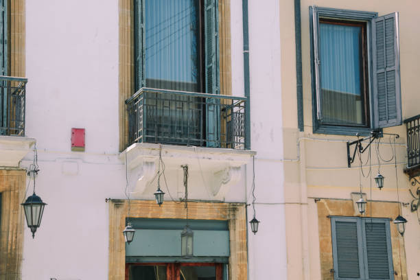 details of windows with lanterns hanging on the wall in Nicosia street, Cyprus