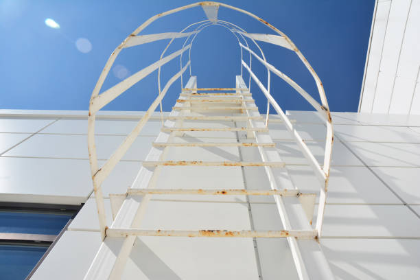 istock A fire escape stairs is a type of emergency exit that is external to a building. Steps to success concept with blurred lights. Fire escape ladder. 1214452015