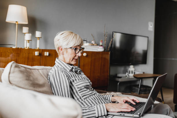 istock Mature woman is working from home 1214453620