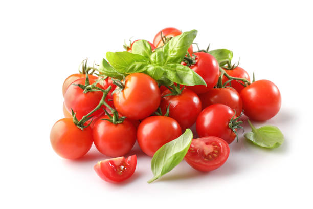 istock Group of ripe red cherry tomatoes and basil leaves 1214453621