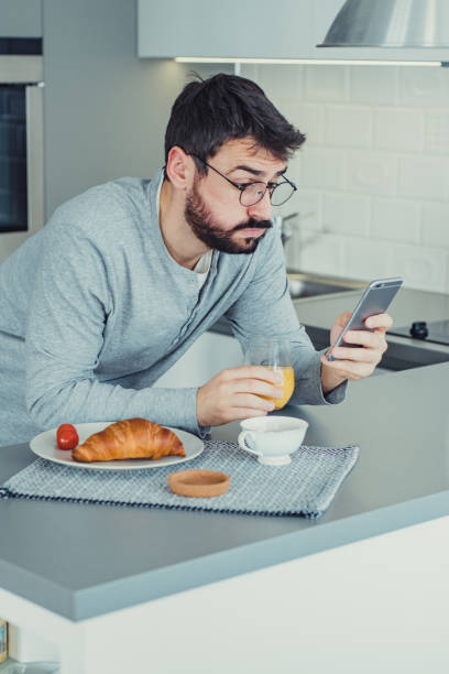 istock Young man is reading online news 1214453685