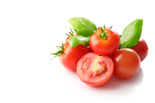 istock Red ripe cherry tomatoes and basil leaves 1214453848