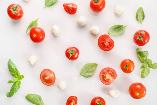 istock Flat lay of ripe cherry tomatoes, mozzarella and basil leaves 1214453864