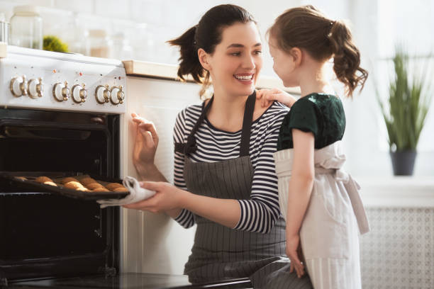 istock family are preparing bakery together 1214453986