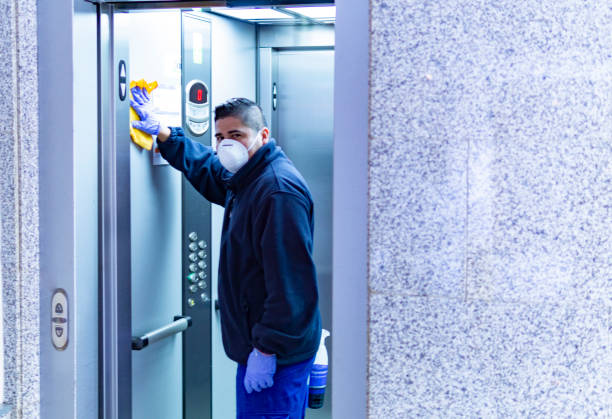 istock worker disinfecting elevator to avoid contagion of coronavirus 1214455188