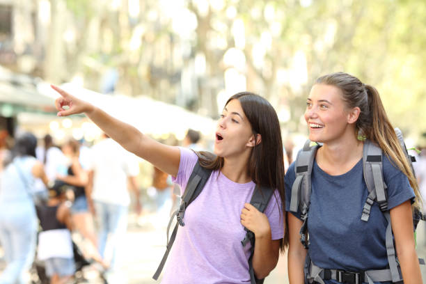 istock Backpackers sightseeing in the street finding landmark 1214455508