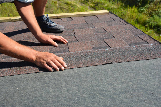 istock Roofer hands laying Asphalt Shingles on house construction roof. Roofing construction with Asphalt Shingles. 1214456666