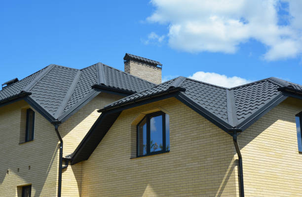 istock Brick house with problem roofing construction and roof gutter pipeline system. Roofing construction. 1214457098