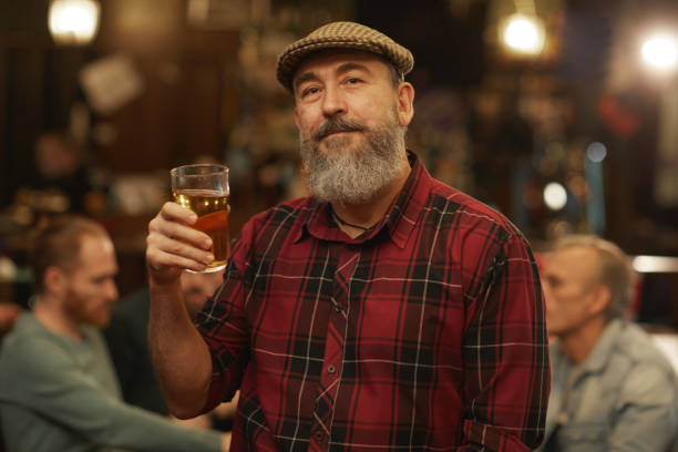 istock Mature man with glass of beer 1214457312