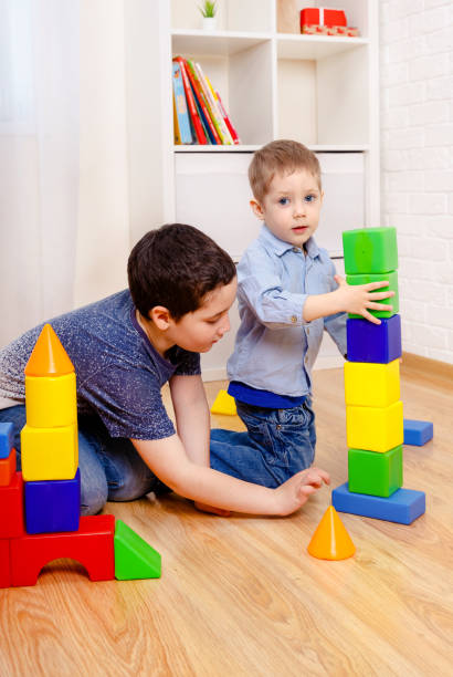 istock Engaging children playing with constructor on floor at home 1214457692