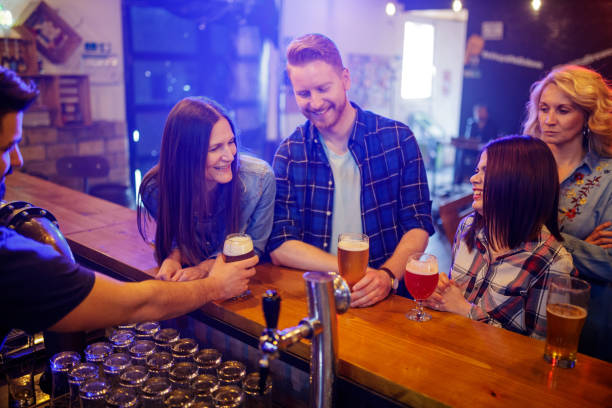 istock Friends relaxing after work in a pub at the bar 1214460879