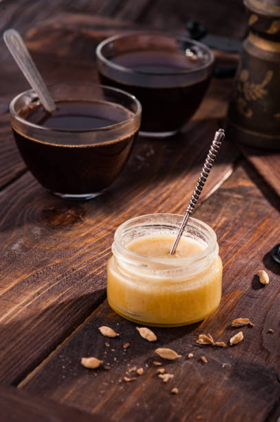 istock Honey with cardamom and coffee on a wooden table. 1214461867