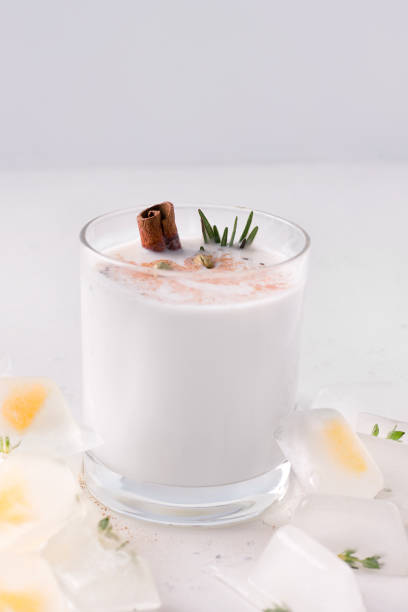 istock Lassi milkshake on a white plate next to ice. Fermented drink 1214462110