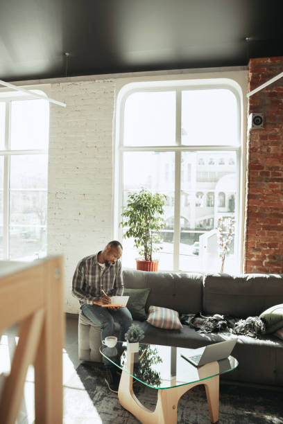 istock African-american man, freelancer during the work in home office while quarantine 1214463100