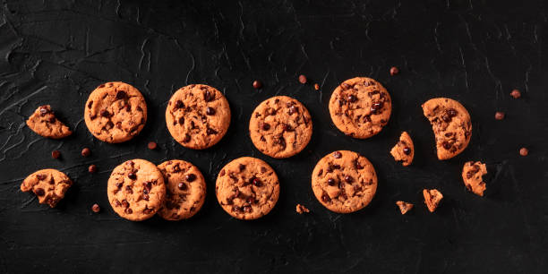 istock Chocolate chip cookies panorama on a black background, shot from above, a flat lay 1214465753