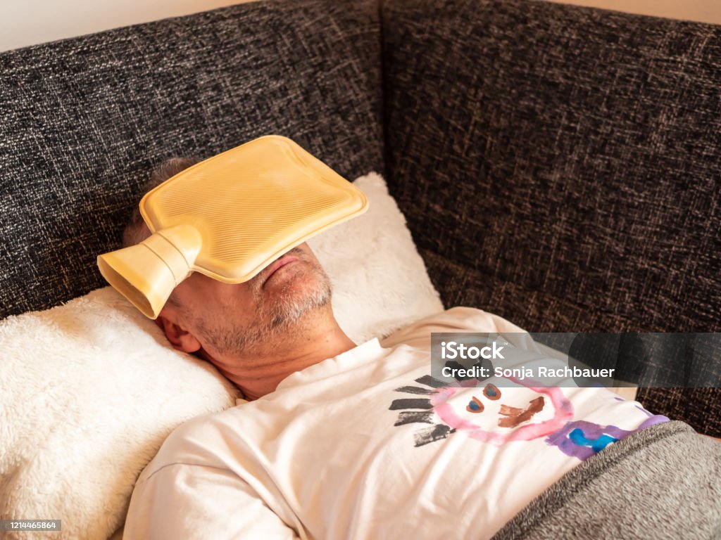 Man Over 40 With A Hot Water Bottle On His Head Coroner Virus Stock Photo -  Download Image Now - iStock